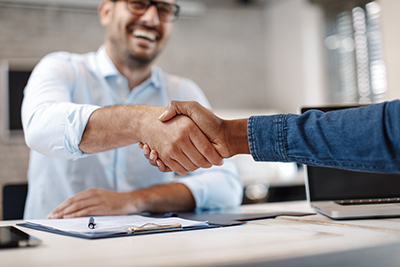 NJ ITM company employee shaking hands with branch manager